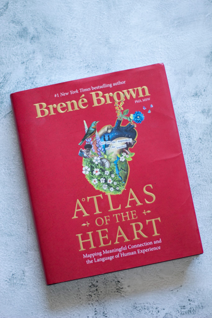 Atlas of the Heart by Brené Brown on a white and grey background as a tool to help with loneliness