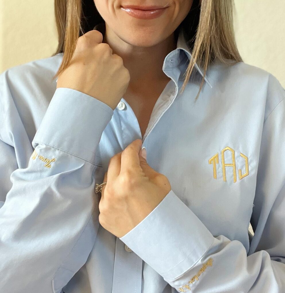 A girl with brown hair in a light blue collared shirt.